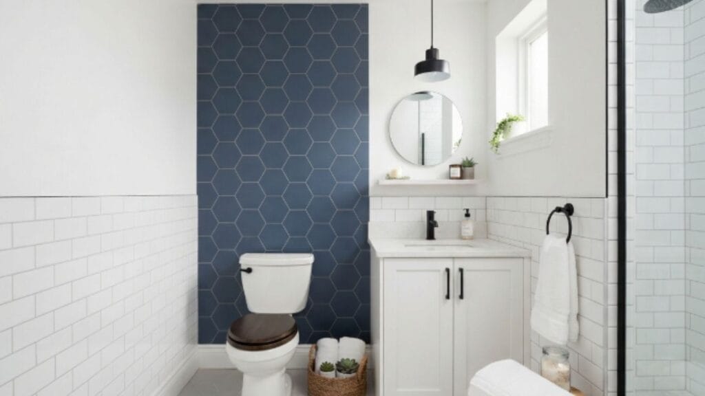 Small bathroom with navy hexagon feature wall and white tile showing affordable bathroom remodel ideas for visual impact