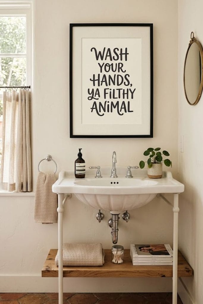 Framed funny bathroom decor sign in a black frame above the sink