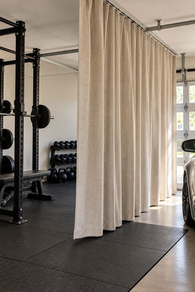 Canvas curtain on a ceiling track dividing the car side from a half garage gym