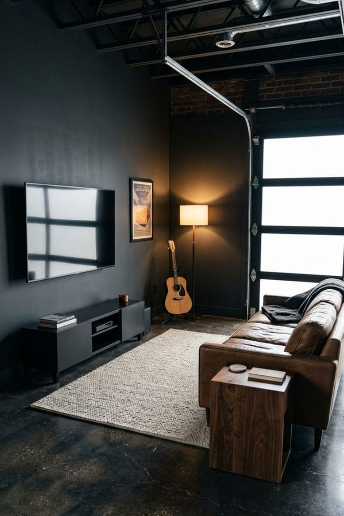 Dark man cave garage ideas with brown leather seating and a wall-mounted TV